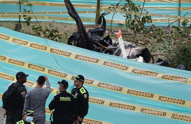 Miembros de la Policía acordonan la zona donde se accidentó hoy una aeronave perteneciente a la Fuerza Aeroespacial Colombiana (FAC), en Cali 