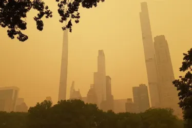 Humo resultante de los incendios forestales canadienses mientras envuelve ayer los edificios cercanos al famoso Central Park de Nueva York. 