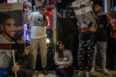 Manifestantes en Tel Aviv (Israel) portan carteles con fotografías de personas secuestradas por militantes de Hamás.